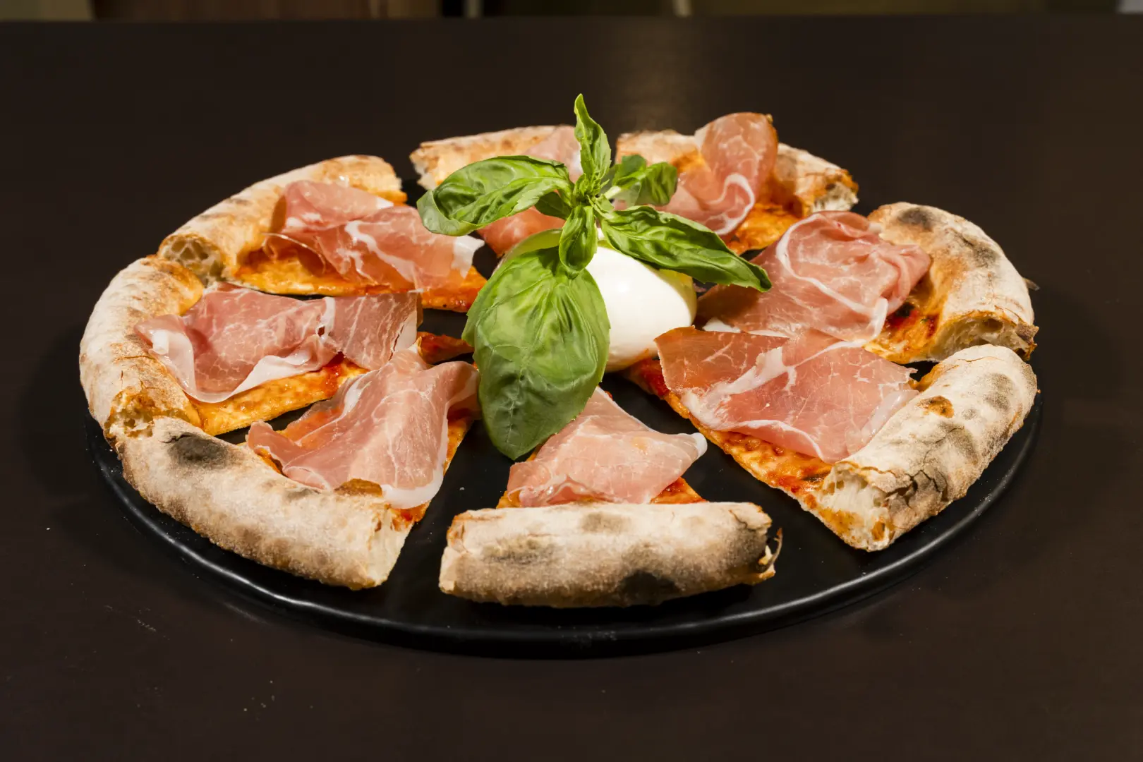 Gourmet pizza with prosciutto crudo and burrata, also available gluten-free and lactose-free